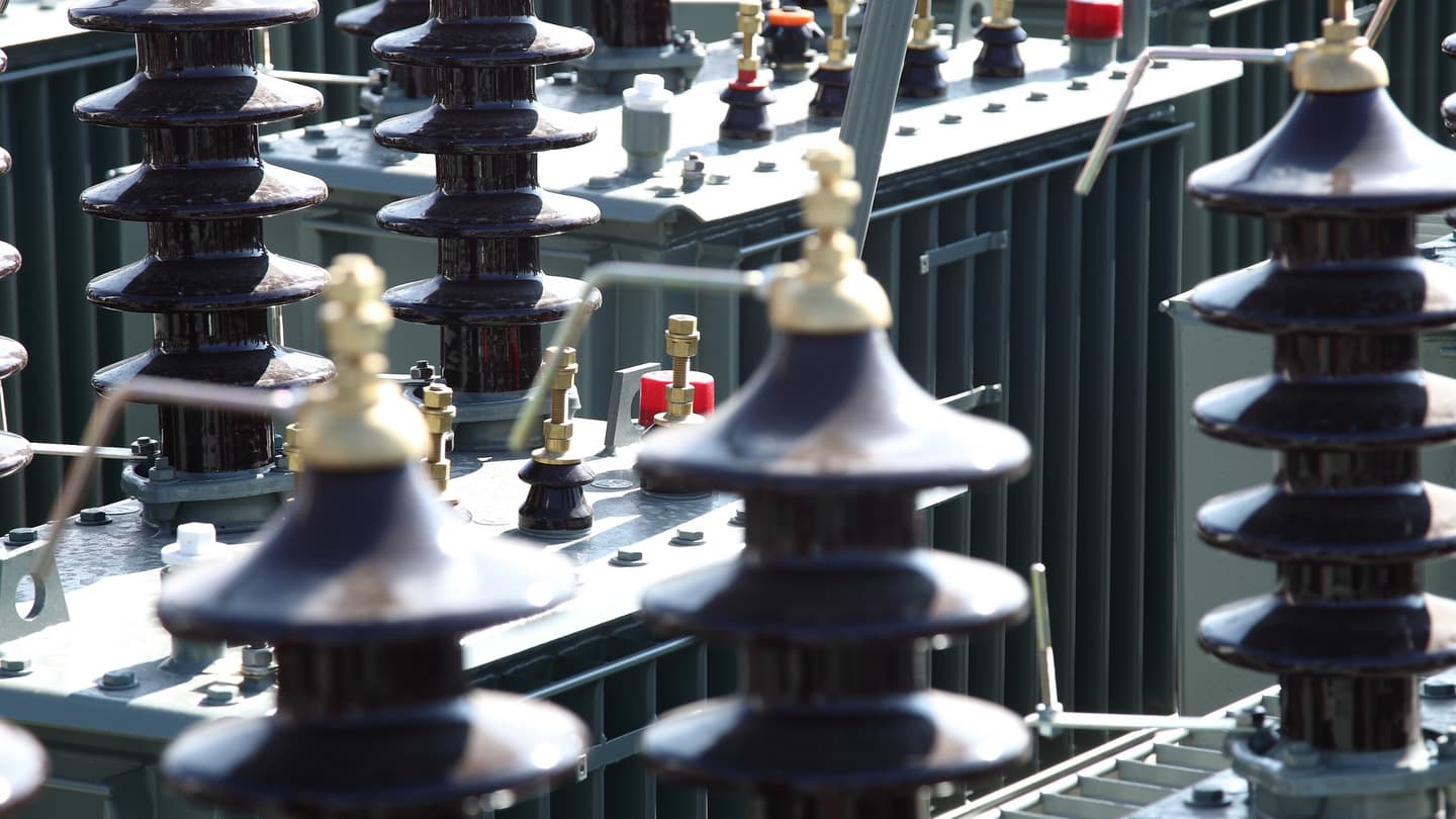 Close-up of porcelain HV bushings on transformer covers
